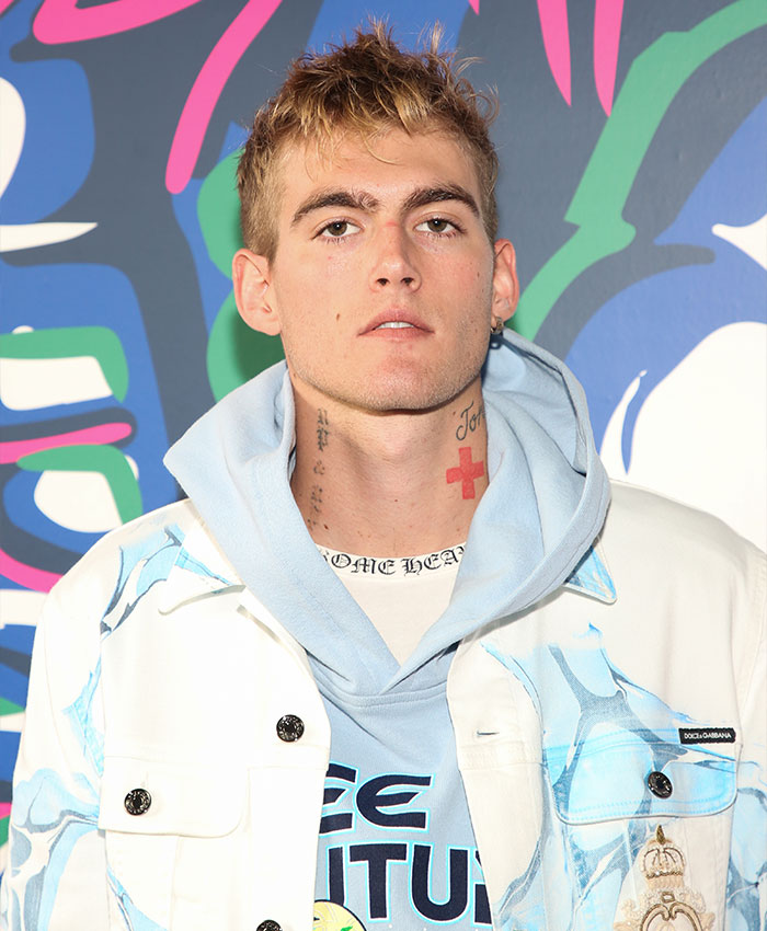 A close-up portrait of Presley Gerber wearing a white jacket and a light blue hoodie. A close-up portrait of Presley Gerber wearing a white jacket and a light blue hoodie.