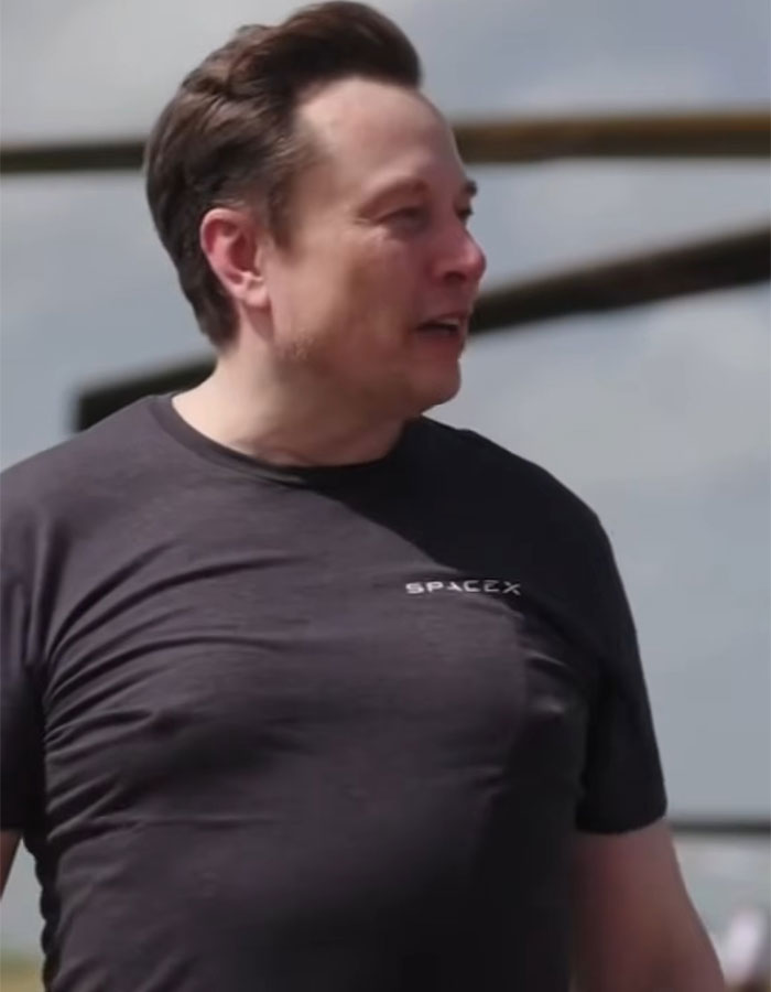 Elon Musk in a SpaceX t-shirt during a spaceport visit