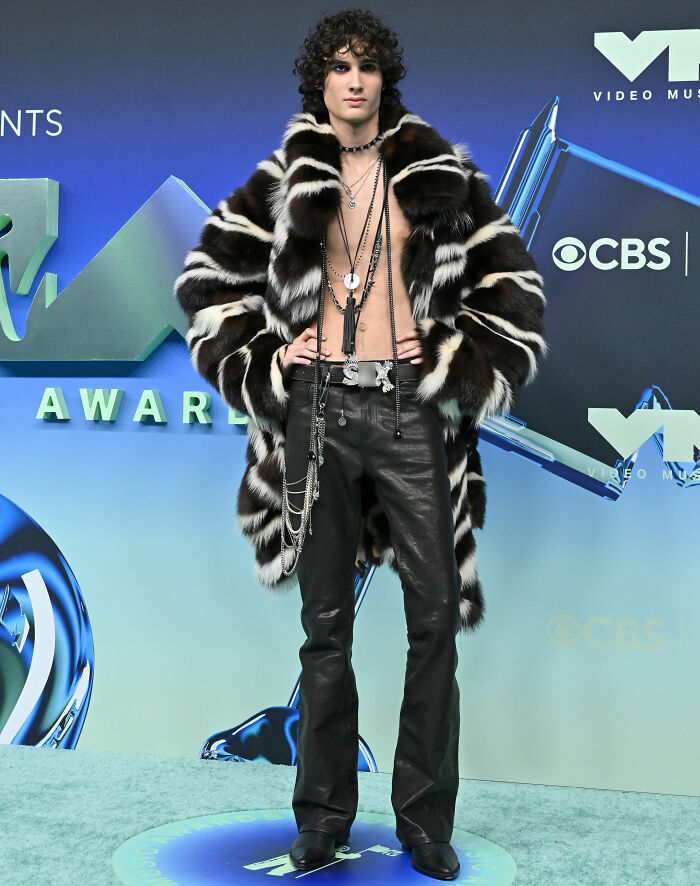 Shirtless celebrity in fur coat and leather pants at VMAs