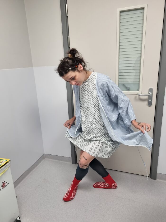 A patient wearing a hospital gown representing a medical journey of losing her eye