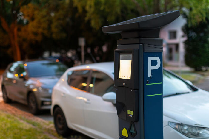 A modern parking meter on a street, highlighting everyday issues raised as court arguments.