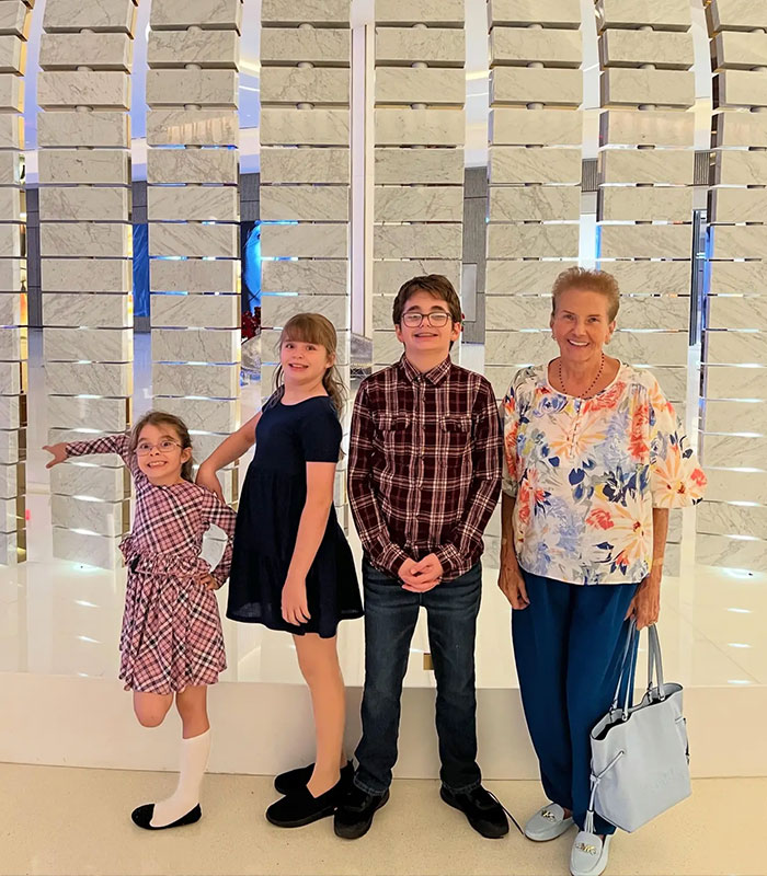 Perez Hilton crisis deepens: Three children and an older woman pose in front of a white tiled wall. Perez Hilton crisis deepens: Three children and an older woman pose in front of a white tiled wall.