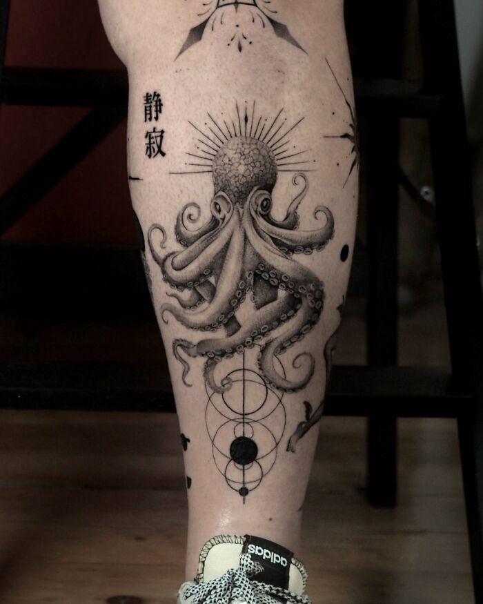 Black ink octopus tattoo with geometric designs on calf