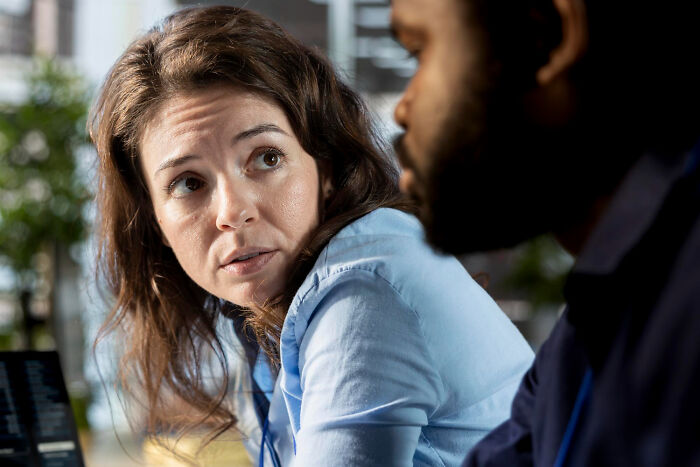 A woman looks up, engaging in something people do that others judge them for.