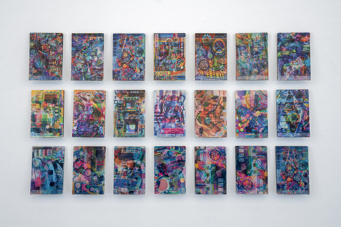 A grid of 21 small rectangular colorful abstract paintings showcasing unusual sculptures-like texture
