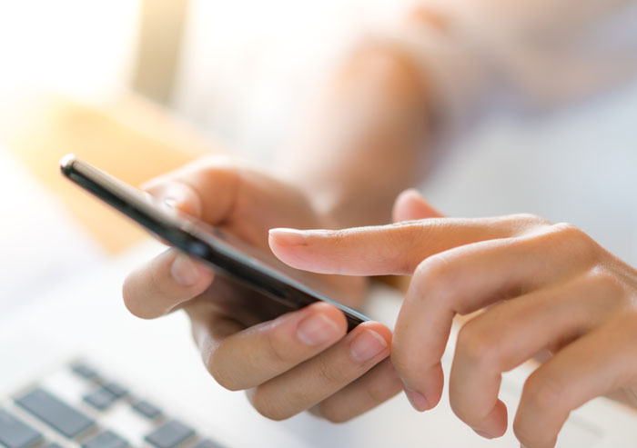A woman doing crazy things to get a crush to like them, interacting with a smartphone.