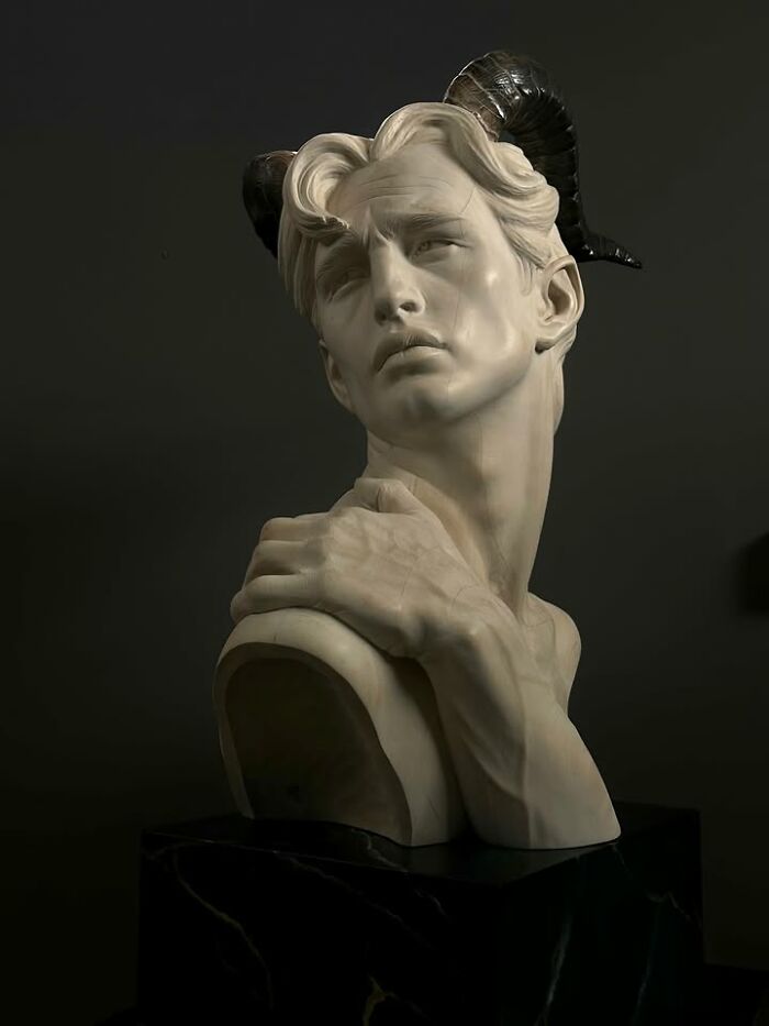 An incredibly lifelike wood sculpture of a man’s bust with horns, sculpted by a Polish artist.
