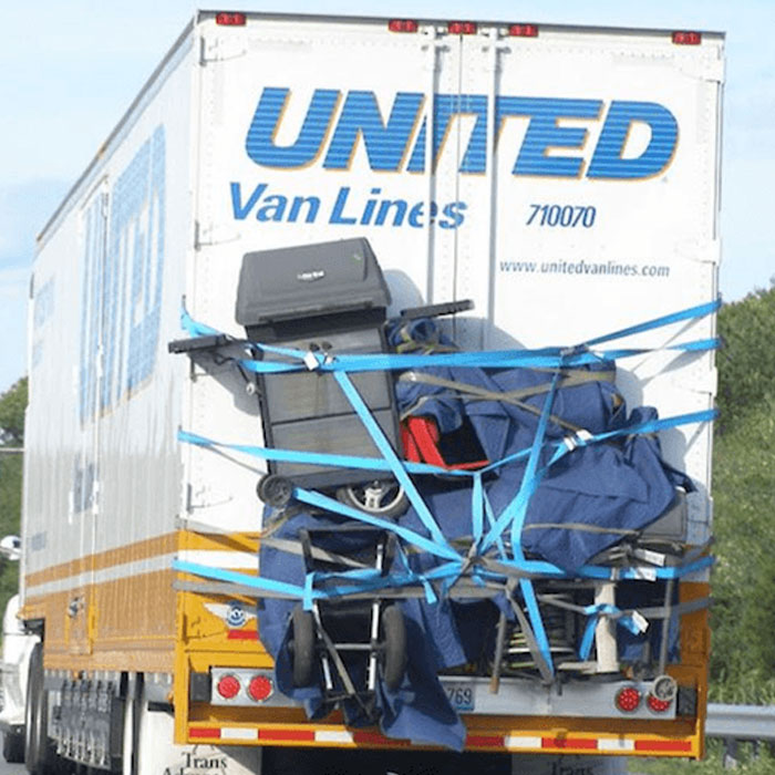 Moving fails picture of United Van Lines truck with loose items tied precariously on back