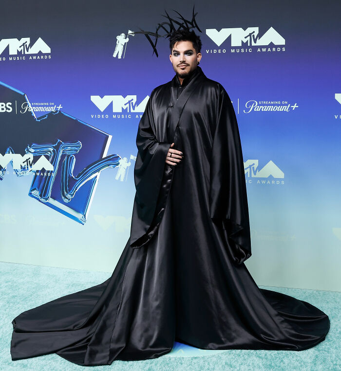 Celebrity in dramatic black satin gown and headpiece at VMAs red carpet