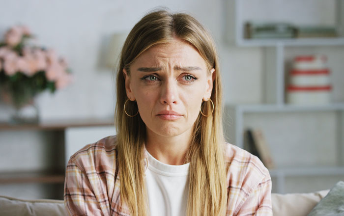 A distraught woman crying, upset over her widowed dad's decision to remarry and cut her out of the will. A distraught woman crying, upset over her widowed dad's decision to remarry and cut her out of the will.
