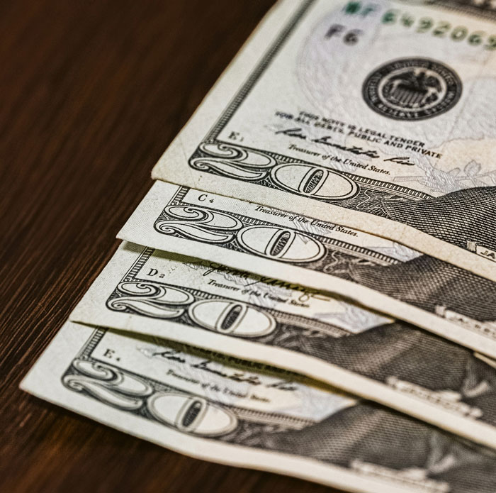 Close-up of US twenty dollar bills, symbolizing financial aspects that can lead to relationships and headaches.