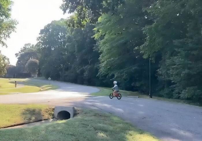 A 5-year-old son on a bike, riding on a road with trees, illustrating the scene of Mom's act. A 5-year-old son on a bike, riding on a road with trees, illustrating the scene of Mom's act.