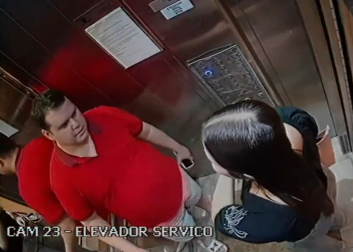 Dating her boss story: CCTV footage of a man in red shirt and a woman inside an elevator Dating her boss story: CCTV footage of a man in red shirt and a woman inside an elevator