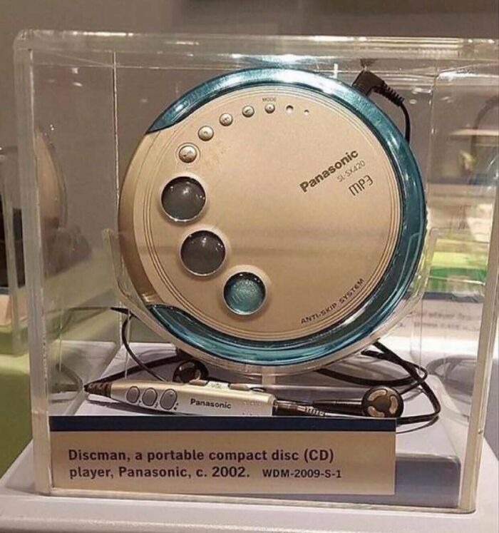 A Panasonic Discman, a portable CD player from c. 2002, displayed in a clear case, showcasing retro tech.