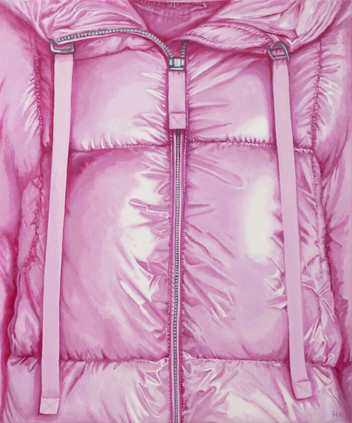 Striking portrait of identity featuring a shiny pink puffer coat with a zipper and drawstrings.