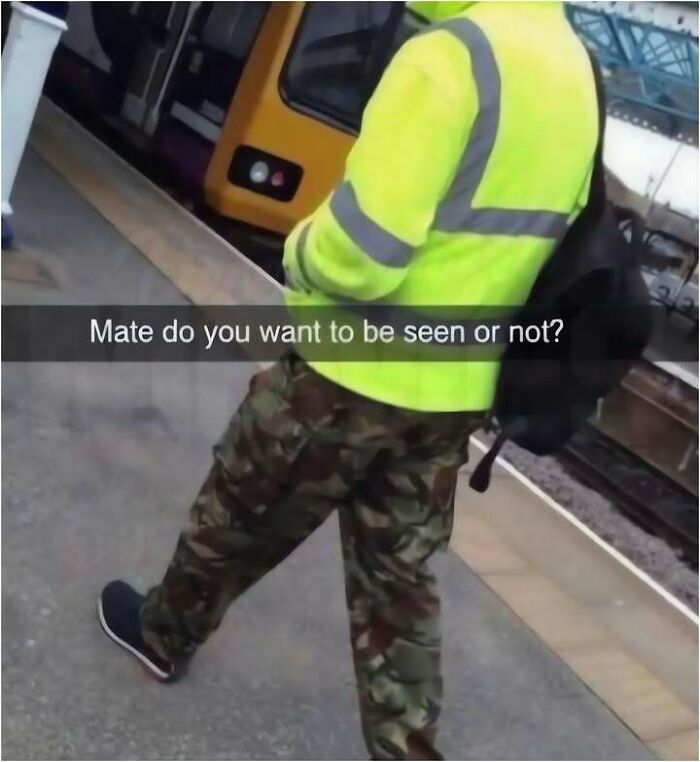 A person in a bright yellow high-vis jacket and camouflage pants, a hilarious meme about conflicting visibility.