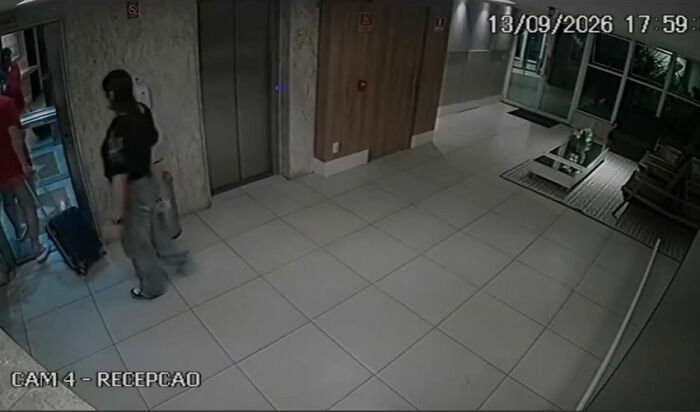 Dating her boss story: security footage of a woman with a suitcase in an apartment reception lobby Dating her boss story: security footage of a woman with a suitcase in an apartment reception lobby