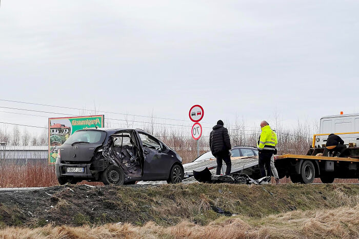 A car accident scene with a tow truck and people, an unexpected end to a life story.