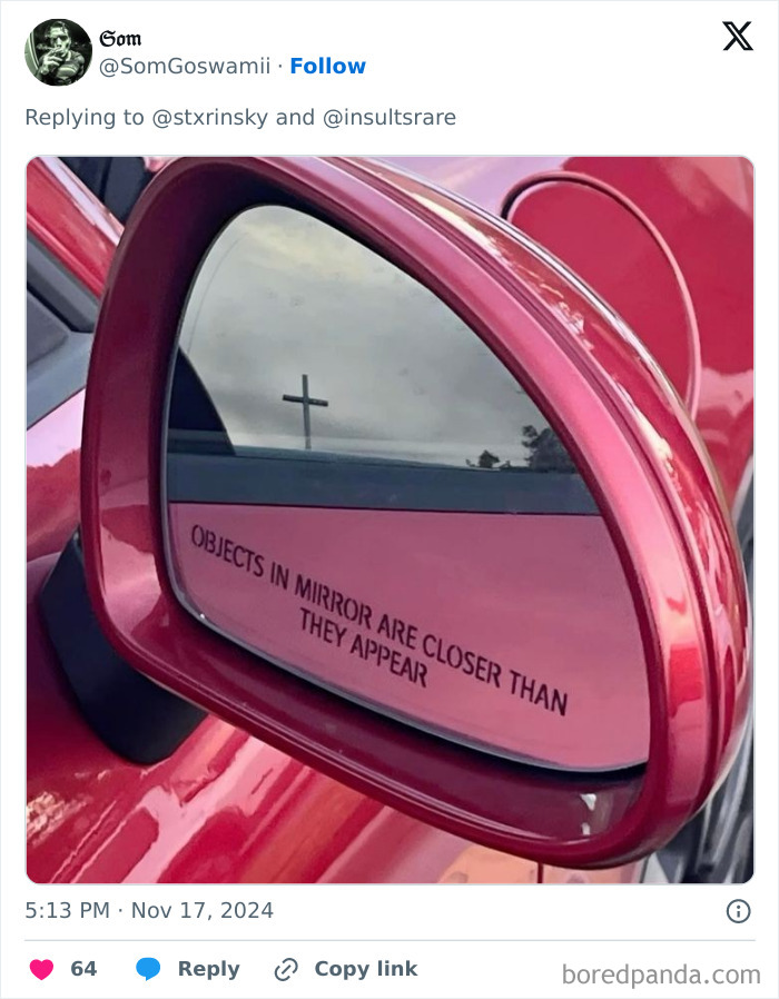 A humorous image of a car side mirror reflecting a cross, with a funny caption below. The comment section is funnier.