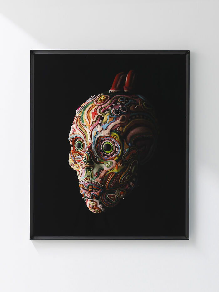 Framed surreal skull-like face crafted from vibrant multi-layered fabrics, representative of unusual sculptures.