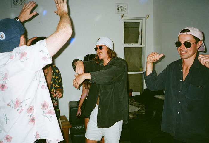 People dancing at a house party, hinting at wild tenant stories and landlord experiences.