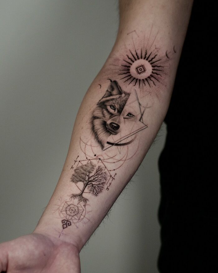 Wolf and tree geometric forearm tattoo with symbolic nature ink design