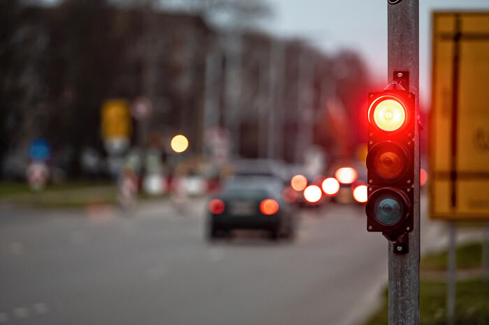 A red traffic light glowing on a city street at dusk, a metaphor for lawyers ridiculous arguments.