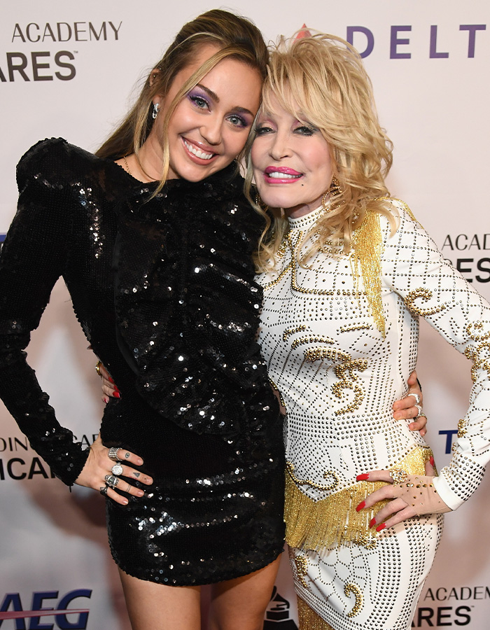 Miley Cyrus and Dolly Parton pose together, amidst discussions of Cyrus' life tragedies.