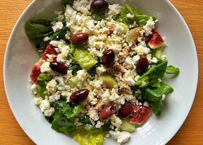 A vibrant salad with lettuce, olives, feta, and figs, typical of a Mediterranean Diet study.