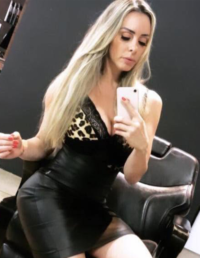 Woman in a black dress taking a selfie, relevant to the story of cosmetic procedures and associated risks. Woman in a black dress taking a selfie, relevant to the story of cosmetic procedures and associated risks.