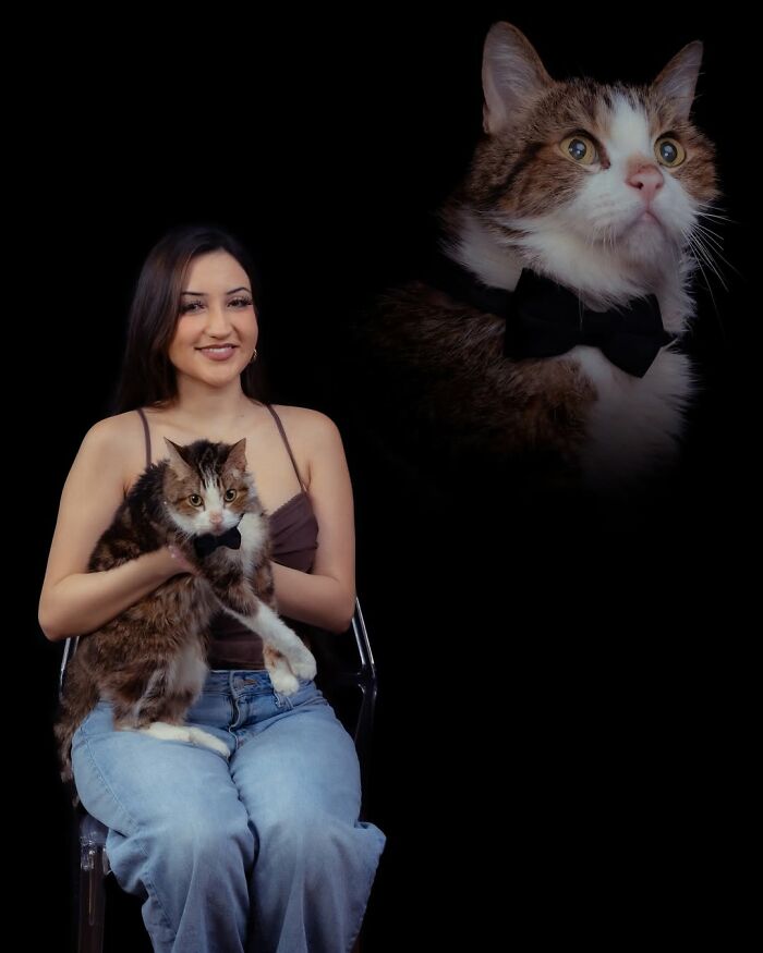 A woman holding her pet cat wearing a bow tie, with a portrait of the cat floating above on a black background, creating quirky portraits of pets and their owners.
