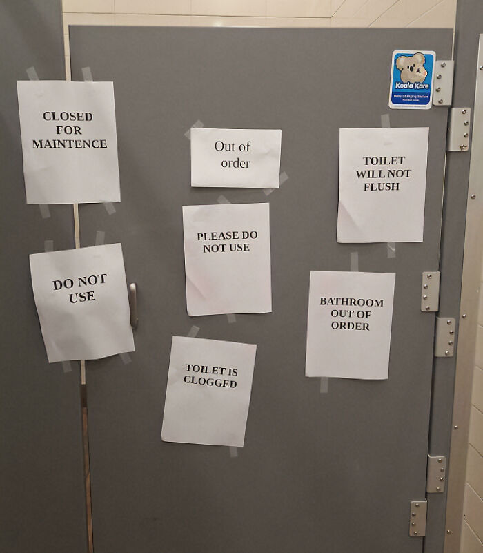 A chaotic sign spotted in the wild, featuring multiple handwritten notices taped to a bathroom door.
