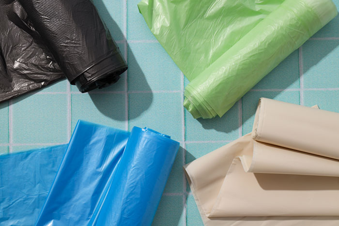 A pile of colorful trash bags, symbolizing unpleasant tenant stories for landlords.