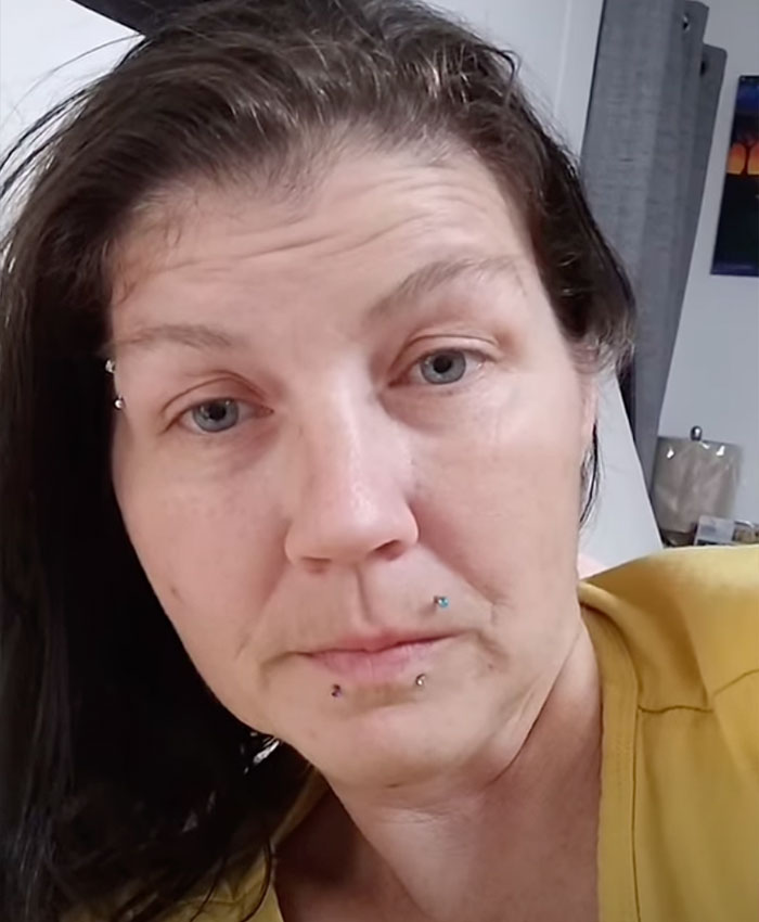 A woman with dark hair and multiple facial piercings, looking serious. This mom and son were charged after a damning confession.