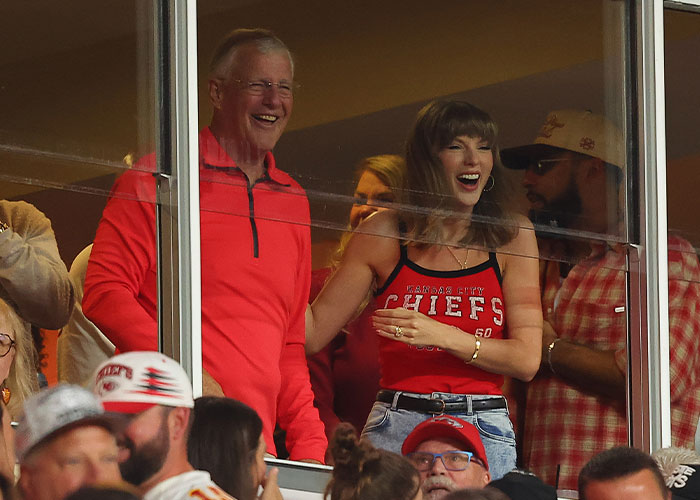 Taylor Swift smiling and laughing while watching Travis Kelce play at a football game Taylor Swift smiling and laughing while watching Travis Kelce play at a football game