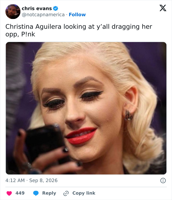 Christina Aguilera looking at her phone, representing Pink losing fan support after controversial posts.
