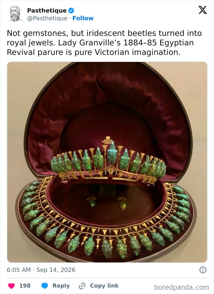 A display of a Victorian Egyptian Revival jewelry set showcasing historic iridescent beetle details.