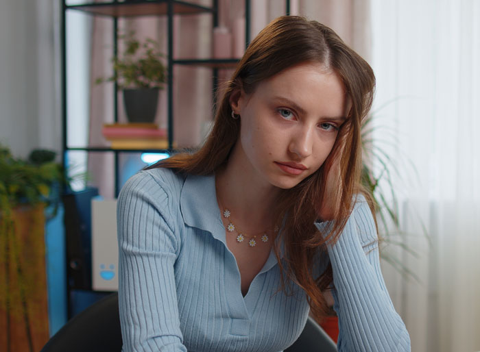 A sad young woman looking at the camera, feeling unloved and hurt by her widowed dad's actions regarding his will. A sad young woman looking at the camera, feeling unloved and hurt by her widowed dad's actions regarding his will.
