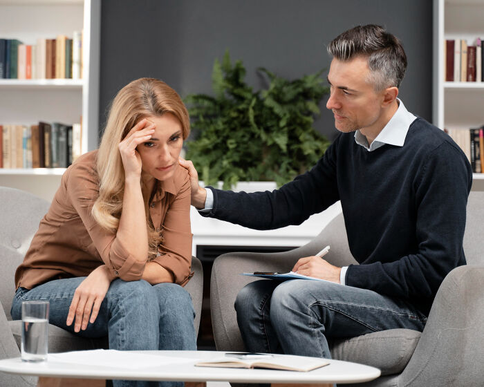 A therapist comforting a distressed woman, helping her navigate dumb ways people ruin their lives.