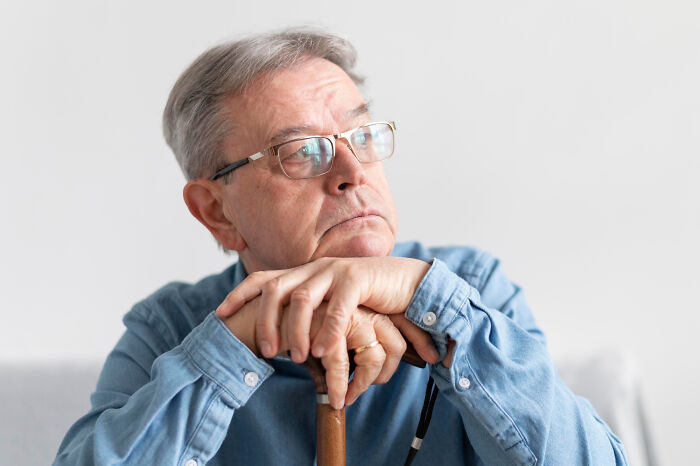 Elderly man looking up, contemplating problems society could be facing in ten years.