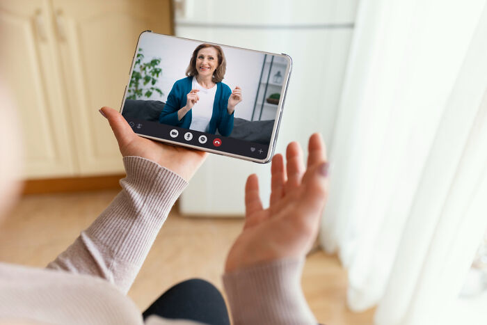 Woman video calling, discussing problems society could be facing in ten years.