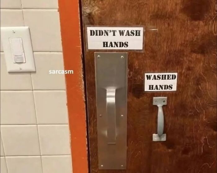 A funny sign on a bathroom door with two handles: DIDNT WASH HANDS and WASHED HANDS. Silly signs with a joke.