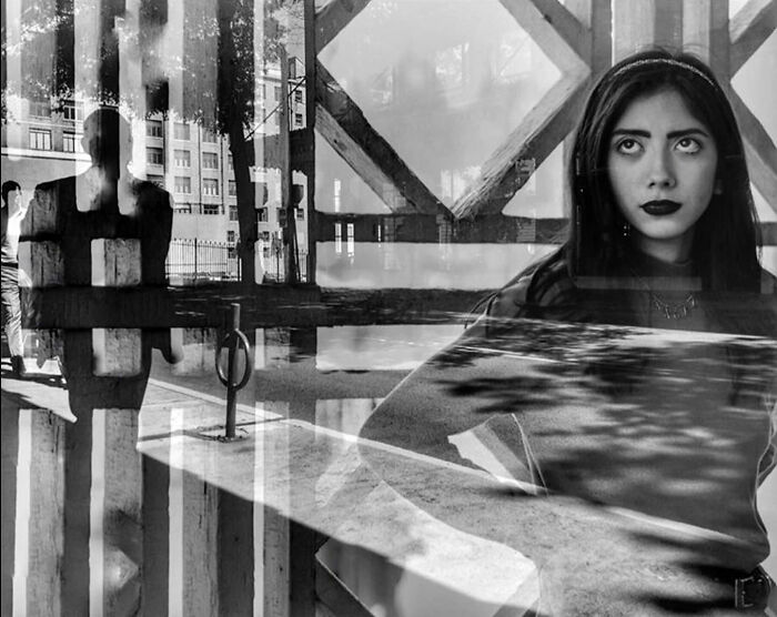 A double exposure street photo by Taylor Coble showing a woman looking up merged with a city street scene.