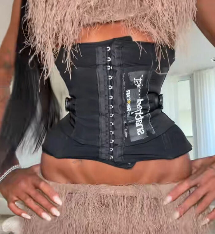 A woman wearing a tight waist-cinching corset after plastic surgery A woman wearing a tight waist-cinching corset after plastic surgery