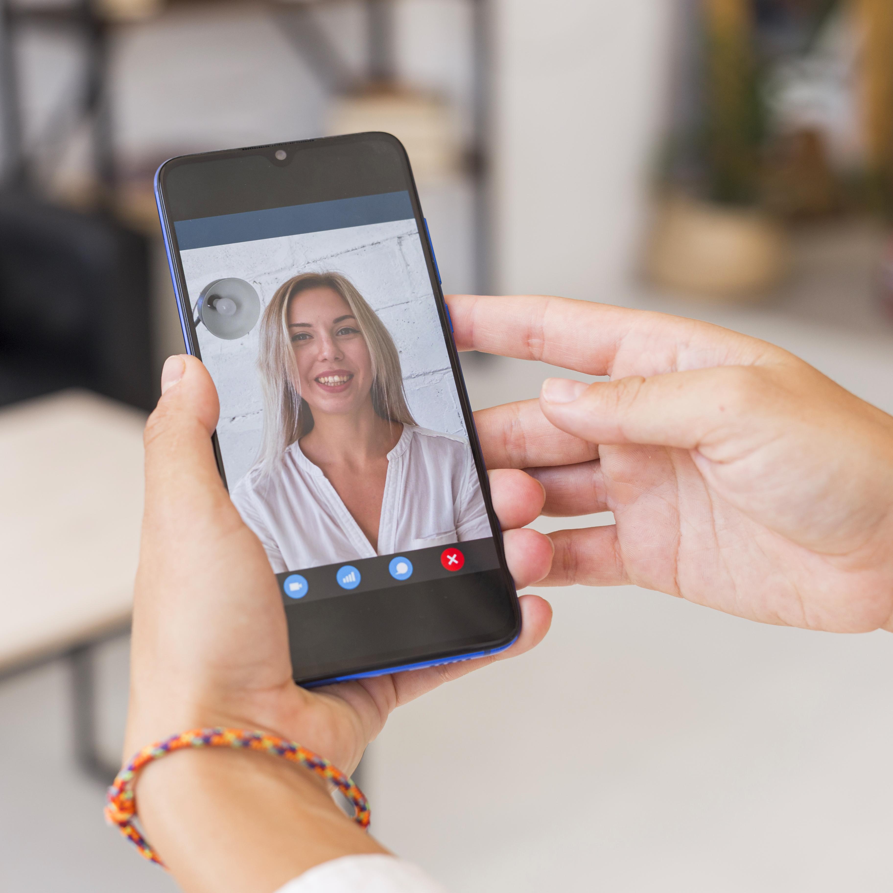 A daughter abroad smiling on a video call with her mother A daughter abroad smiling on a video call with her mother