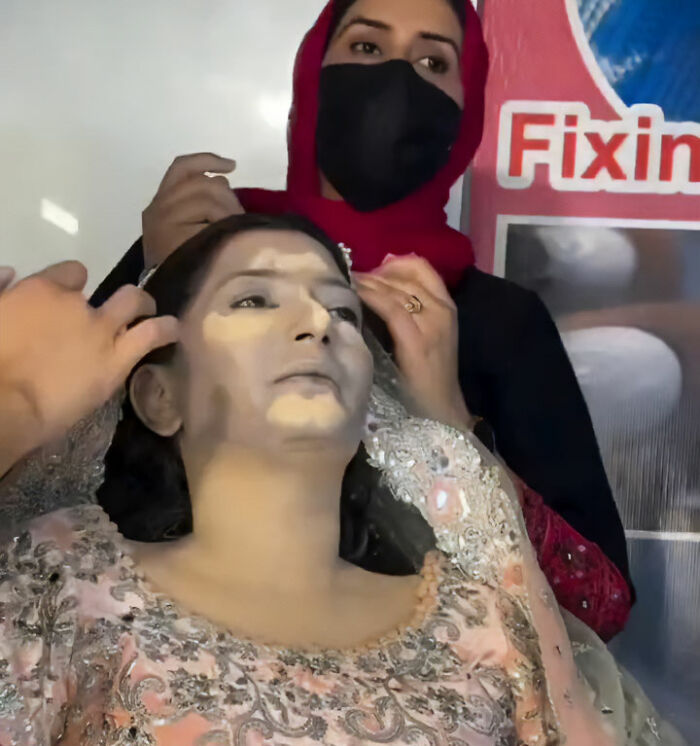 Makeup artist applying foundation on a woman's face during her dramatic wedding day transformation. Makeup artist applying foundation on a woman's face during her dramatic wedding day transformation.