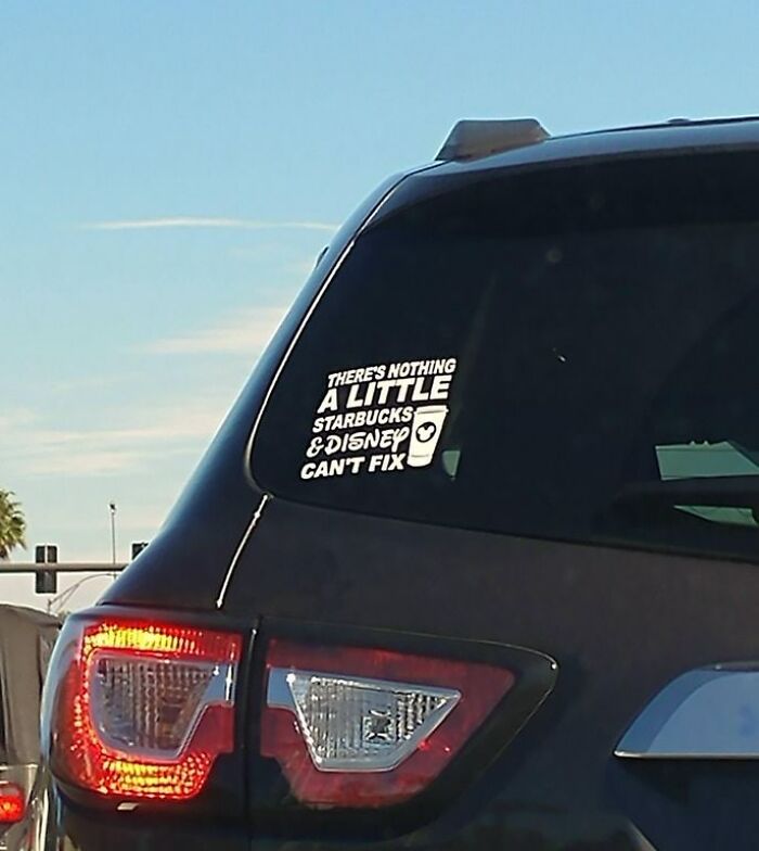 A car with a sticker that says 'There's nothing a little Starbucks and Disney can't fix' showcasing the horrid world.