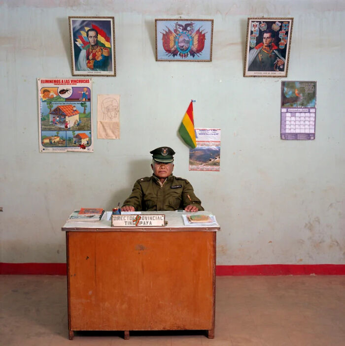 A photographer's project showing a uniformed officer at a simple desk, highlighting the people and offices of global bureaucracy.