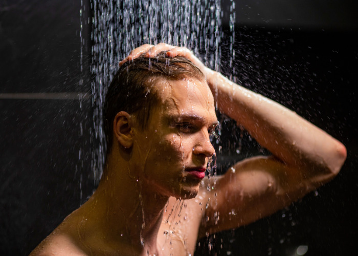 A man showering after a gym workout