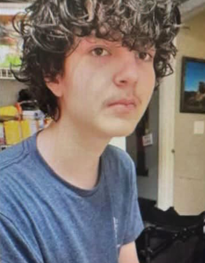 A young man with curly hair and a mustache, the missing son found.